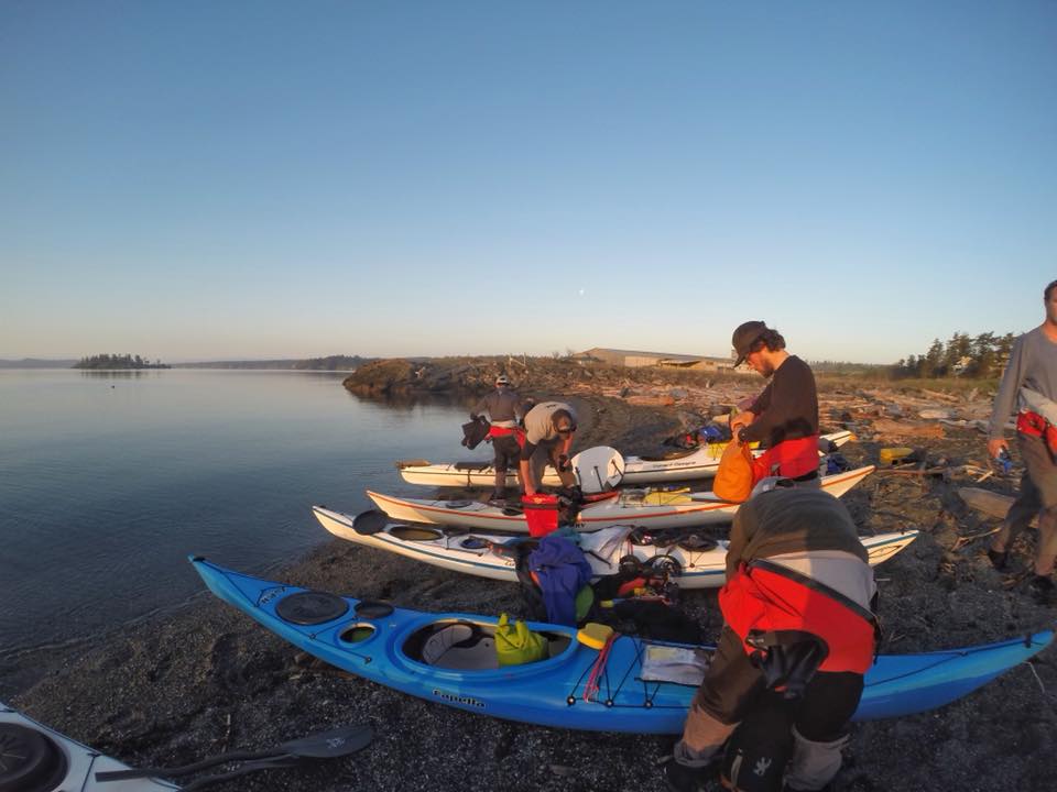 Packing kayaks at the beach during sunrise