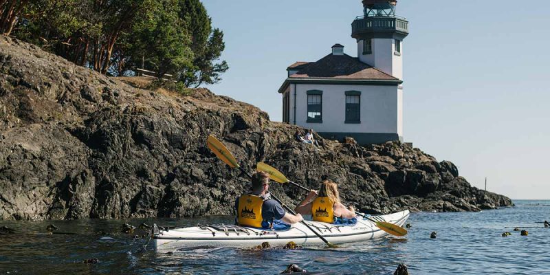 Kayakers with the lighthouse in the background